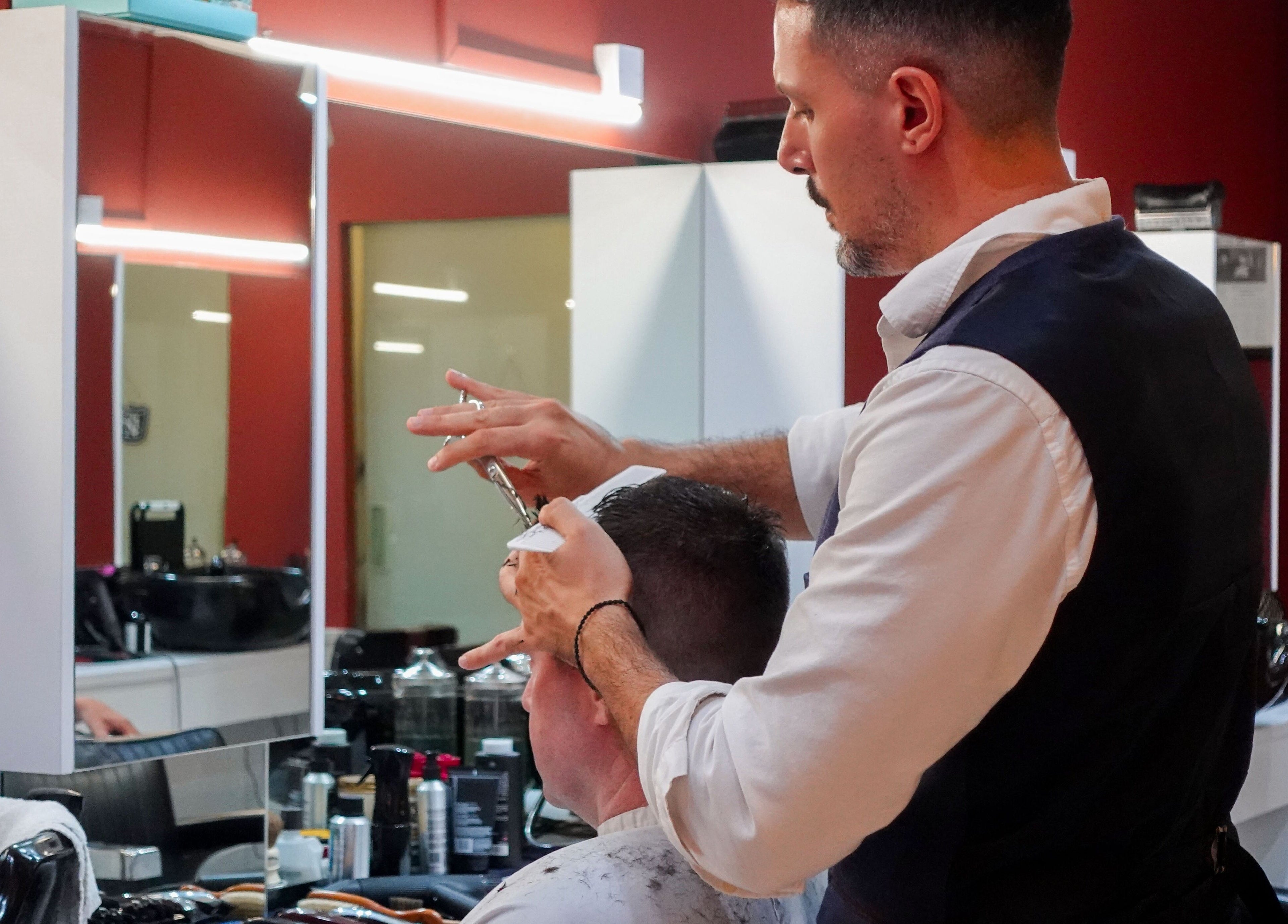Stylist performing haircut at Jermyn Street salon in Singapore, Singapore, SG.