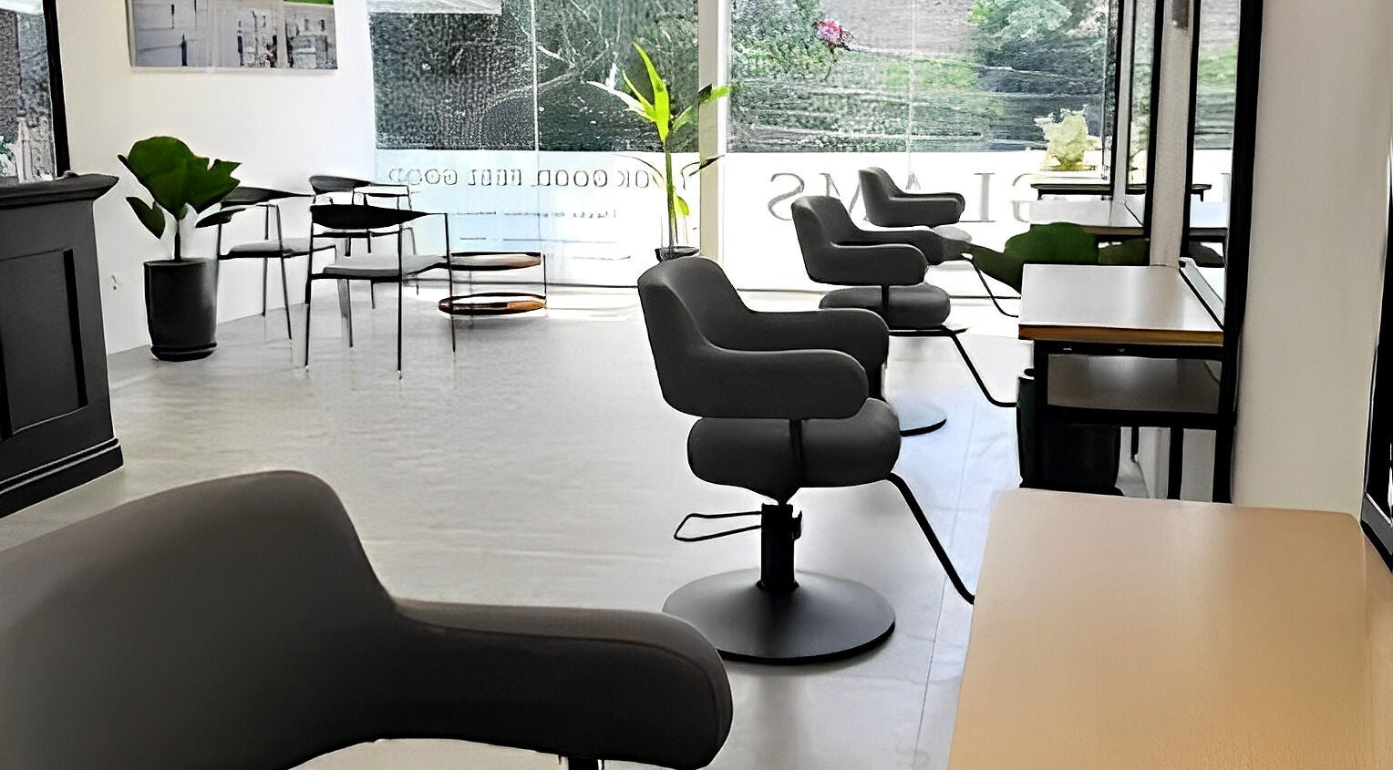 Modern interior of Glams Hair Lounge in Daerah Khusus Ibukota Jakarta with sleek styling chairs.