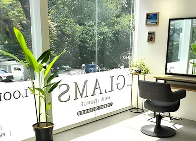 Bright, modern salon interior at Glams Hair Lounge in Daerah Khusus Ibukota Jakarta, ID with lush greenery.