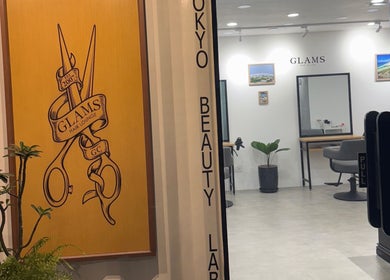 Entrance to Glams Hair Lounge in Daerah Khusus Ibukota Jakarta with logo and interior view.