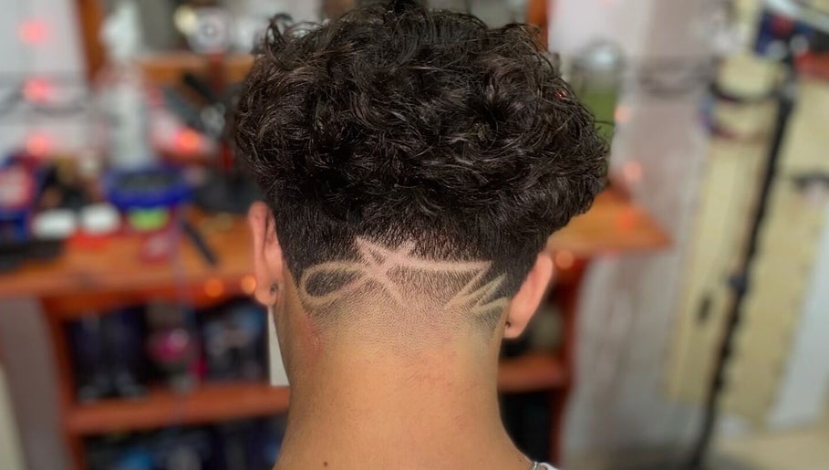 Creative hair design at Gianluca_cutz, Ħaż-żabbar, MT showcasing intricate fade pattern.
