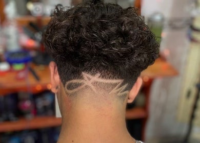 Creative hair design at Gianluca_cutz, Ħaż-żabbar, MT showcasing intricate fade pattern.