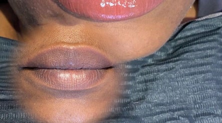 Close-up of glossy lips reflected in a mirror at LabtoLips, Halstead, England, GB.