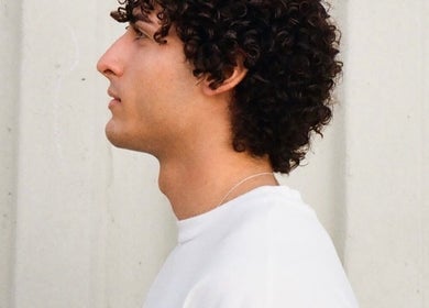 Profile of a person with curly hair styled at Mens Haircut Windsor by Ritzy’s, Windsor, England, GB.