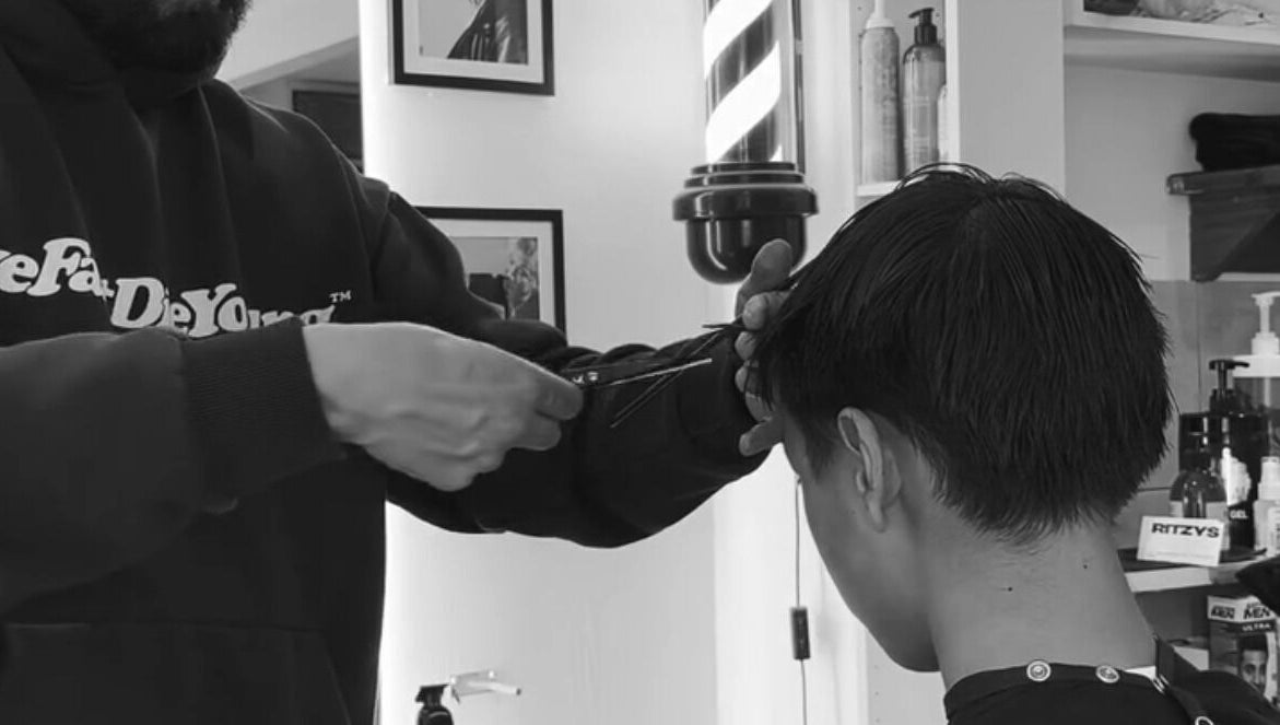 Expert stylist performing a precise haircut at Mens Haircut Windsor by Ritzy’s, Windsor, England, GB.