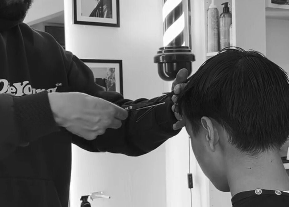 Expert stylist performing a precise haircut at Mens Haircut Windsor by Ritzy’s, Windsor, England, GB.