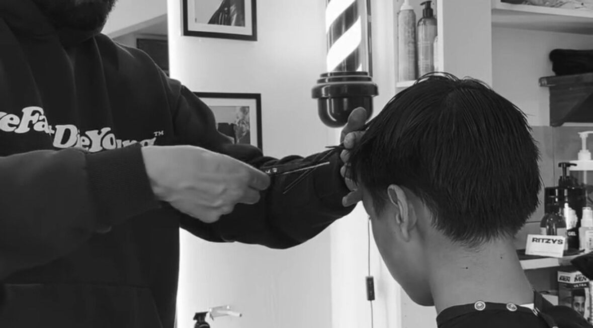 Expert stylist performing a precise haircut at Mens Haircut Windsor by Ritzy’s, Windsor, England, GB.