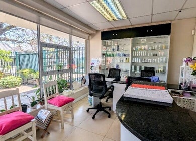 Bright and welcoming reception area at Pepa Health & Beauty, Pretoria, Gauteng, ZA with cozy chairs and product display.