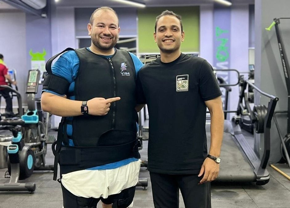 Two smiling men at Abdallah gym, محافظة القاهرة‬, محافظة القاهرة‬, EG, in a modern fitness environment.