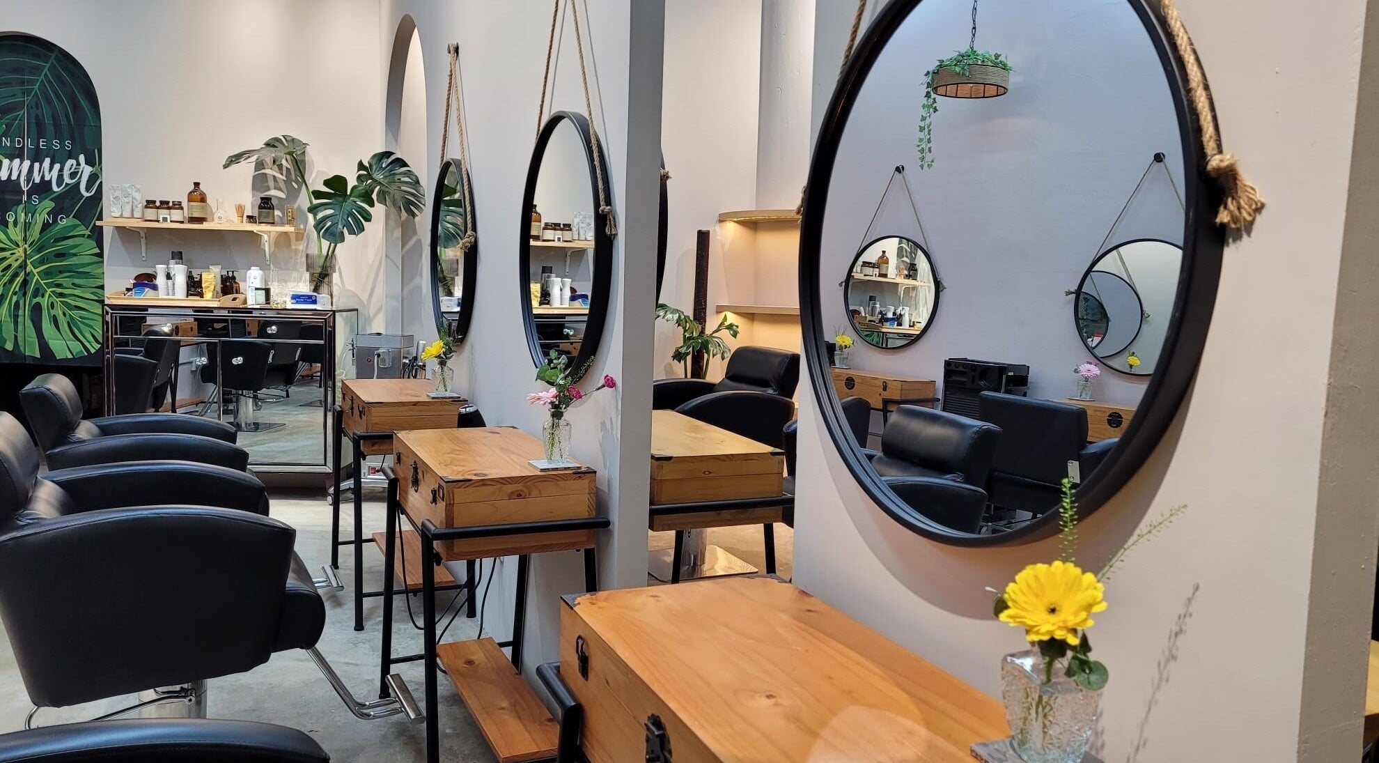 Modern styling chairs and mirrors at Colour Haven Hair Studio, Singapore, Singapore, SG reflect a chic ambiance.