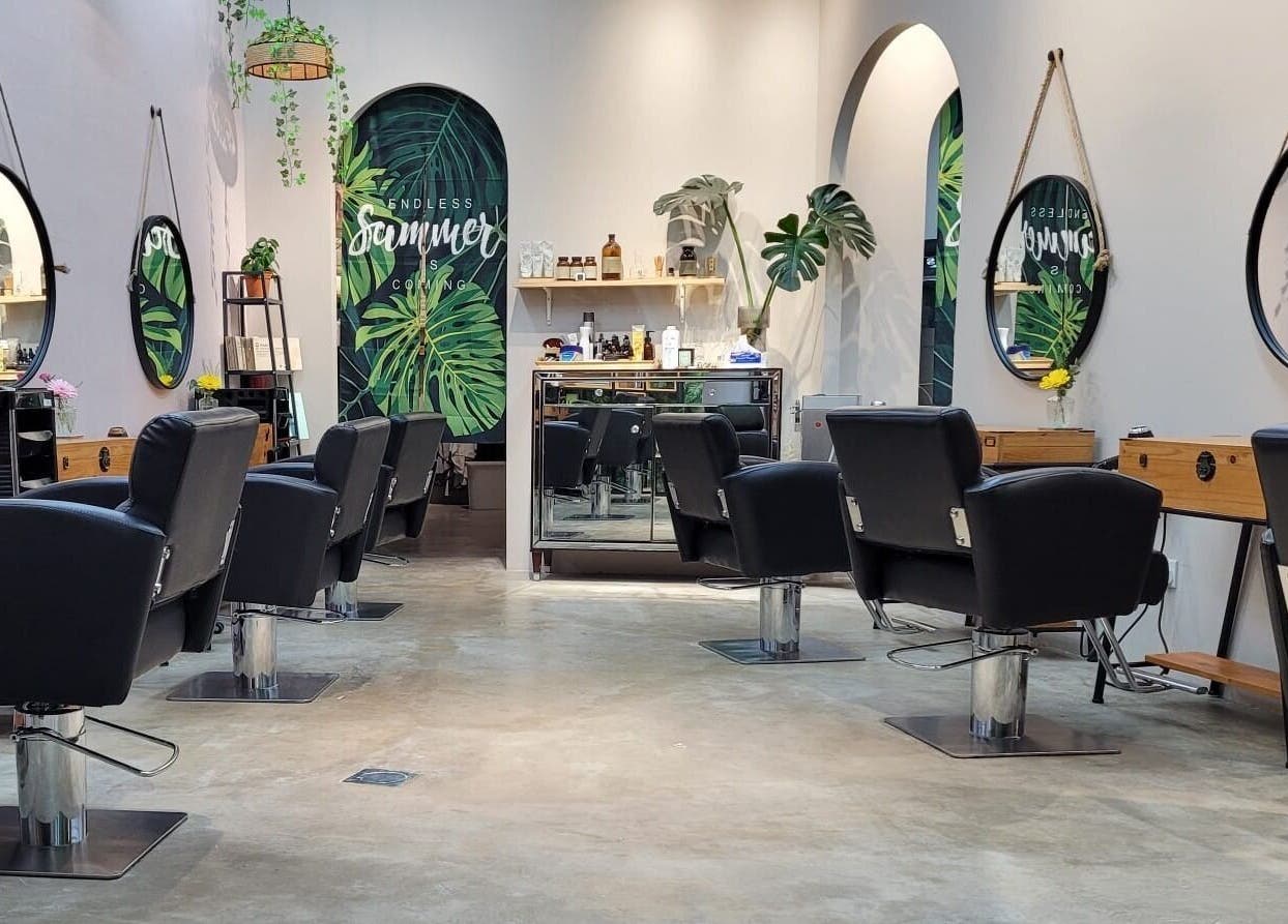 Interior view of Colour Haven Hair Studio in Singapore, SG with stylish chairs and mirrors.