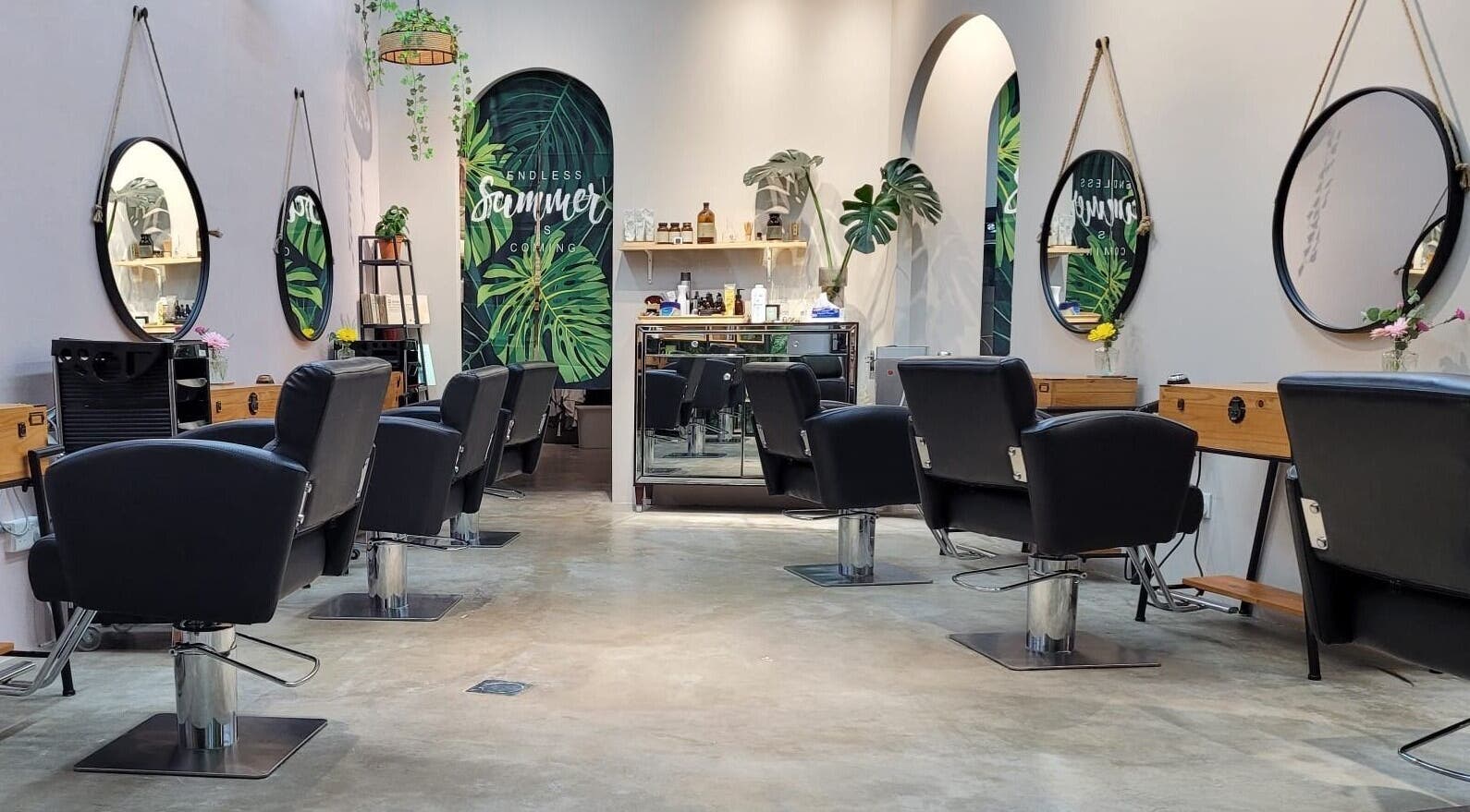 Interior view of Colour Haven Hair Studio in Singapore, SG with stylish chairs and mirrors.