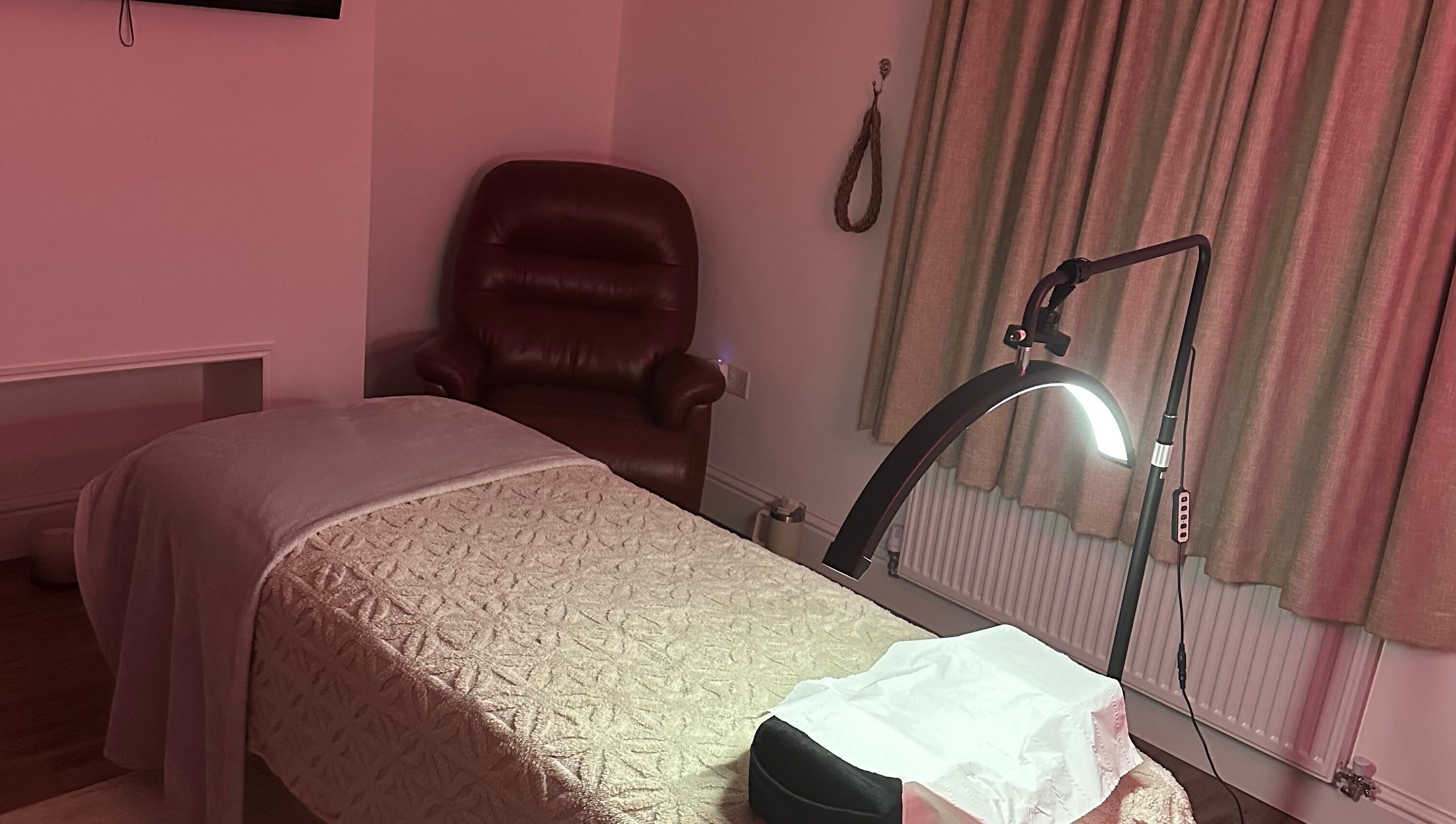 Cozy treatment room at Dolled Up, March, England, GB with soft lighting and comfortable seating.