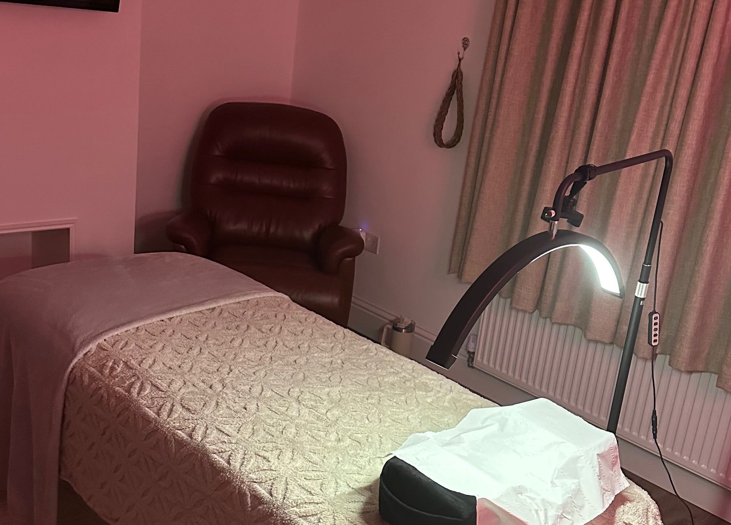 Cozy treatment room at Dolled Up, March, England, GB with soft lighting and comfortable seating.