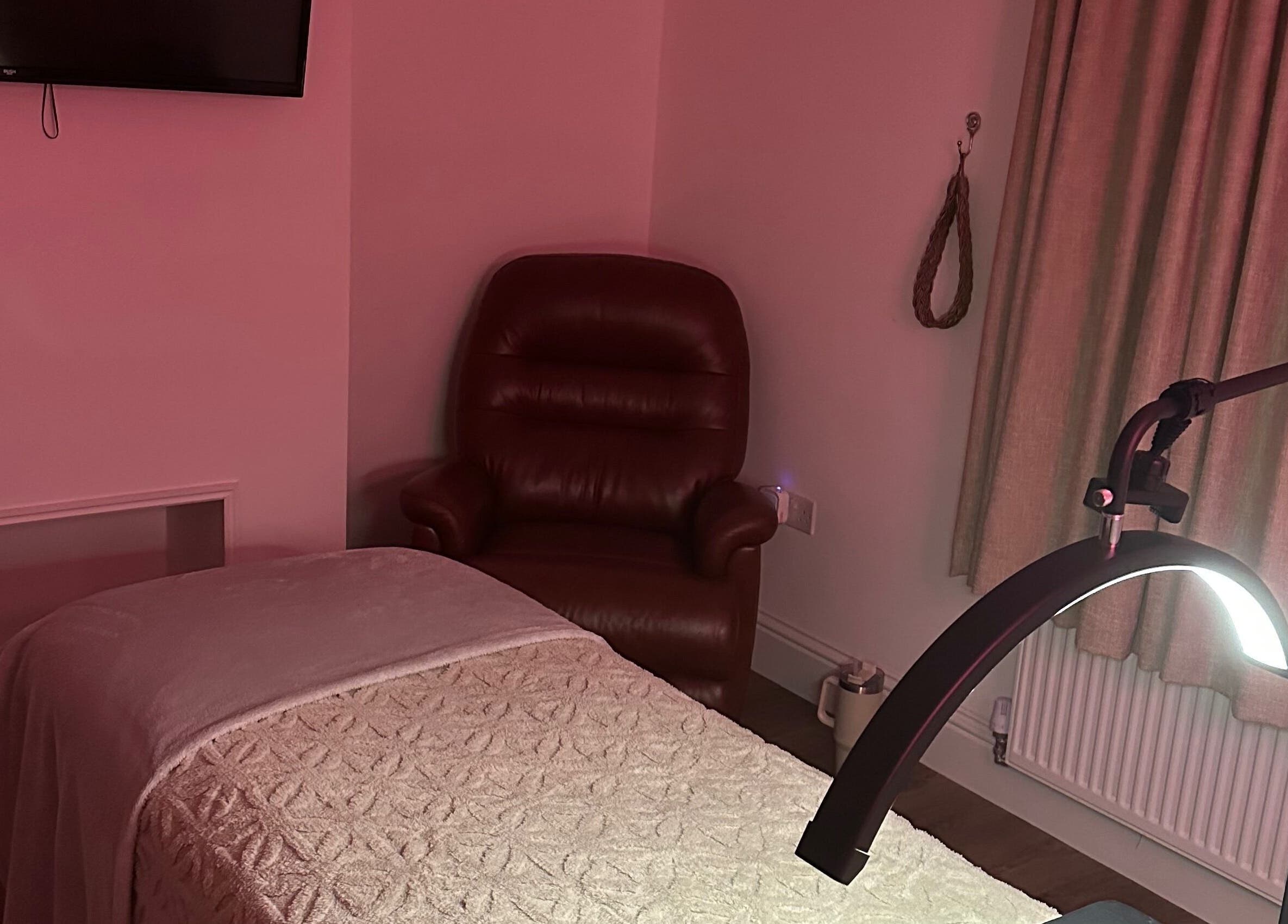 Relaxing massage room at Dolled Up, March, England, GB, featuring a cozy chair and ambient lighting.