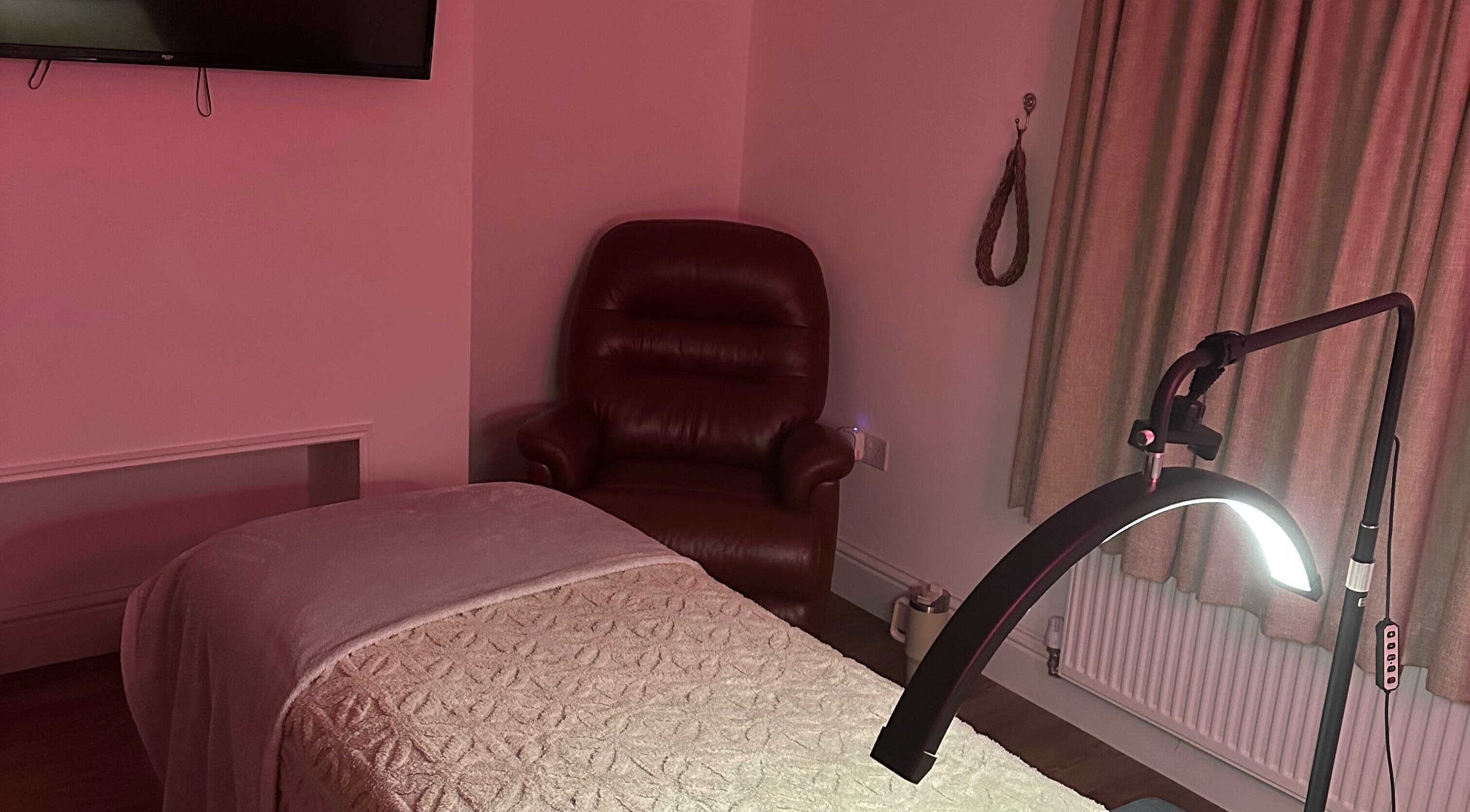 Relaxing massage room at Dolled Up, March, England, GB, featuring a cozy chair and ambient lighting.