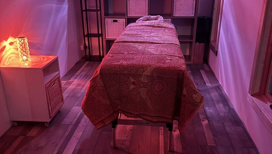 Relaxing massage room at Amethyst Touch, Poole, England, GB, with ambient lighting and soothing decor.