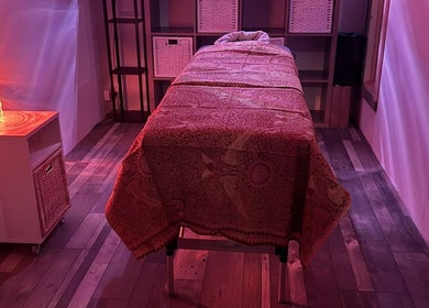 Relaxing massage room at Amethyst Touch, Poole, England, GB, with ambient lighting and soothing decor.