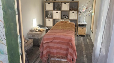 Serene spa room at Amethyst Touch, Poole, England, GB featuring a cozy massage table and calming decor.