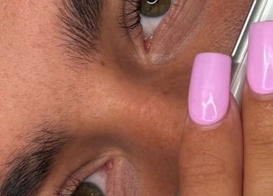 Close-up of pink manicured nails from Lashed By Lucy in Farnham, England, GB enhancing beauty and style.
