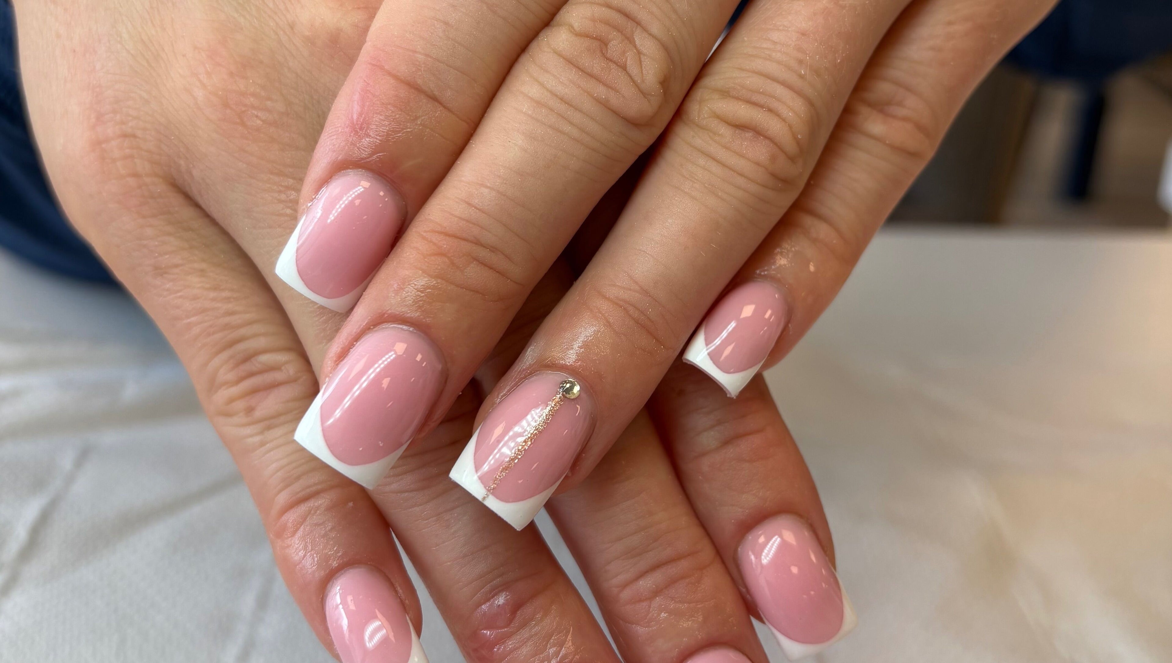 Elegant French manicure featuring pink and white tips at Glam By Jas, Limerick, County Limerick, IE.