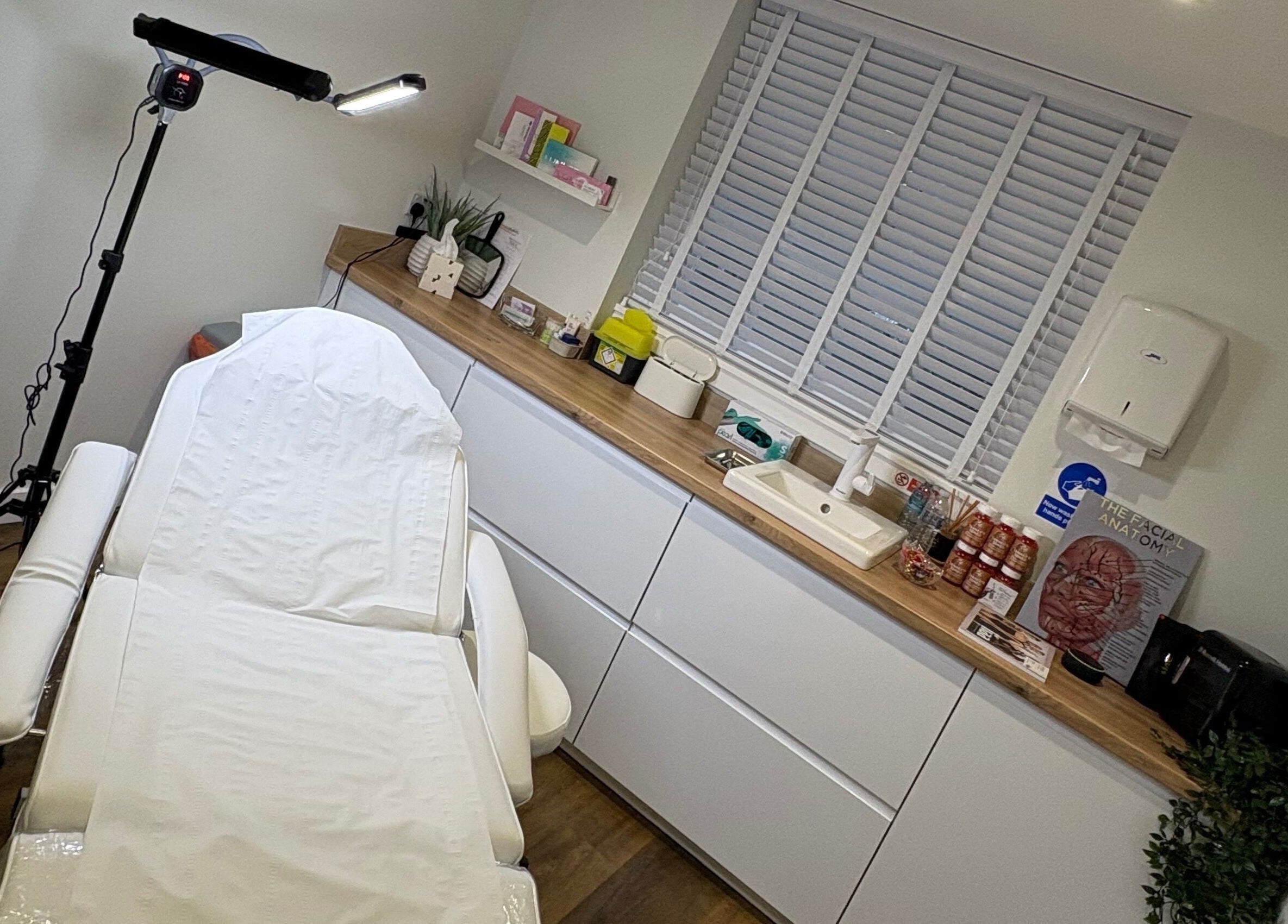 Treatment room at Enhance With Claire, Dunfermline, Scotland, GB with a luxurious massage bed and calming decor.