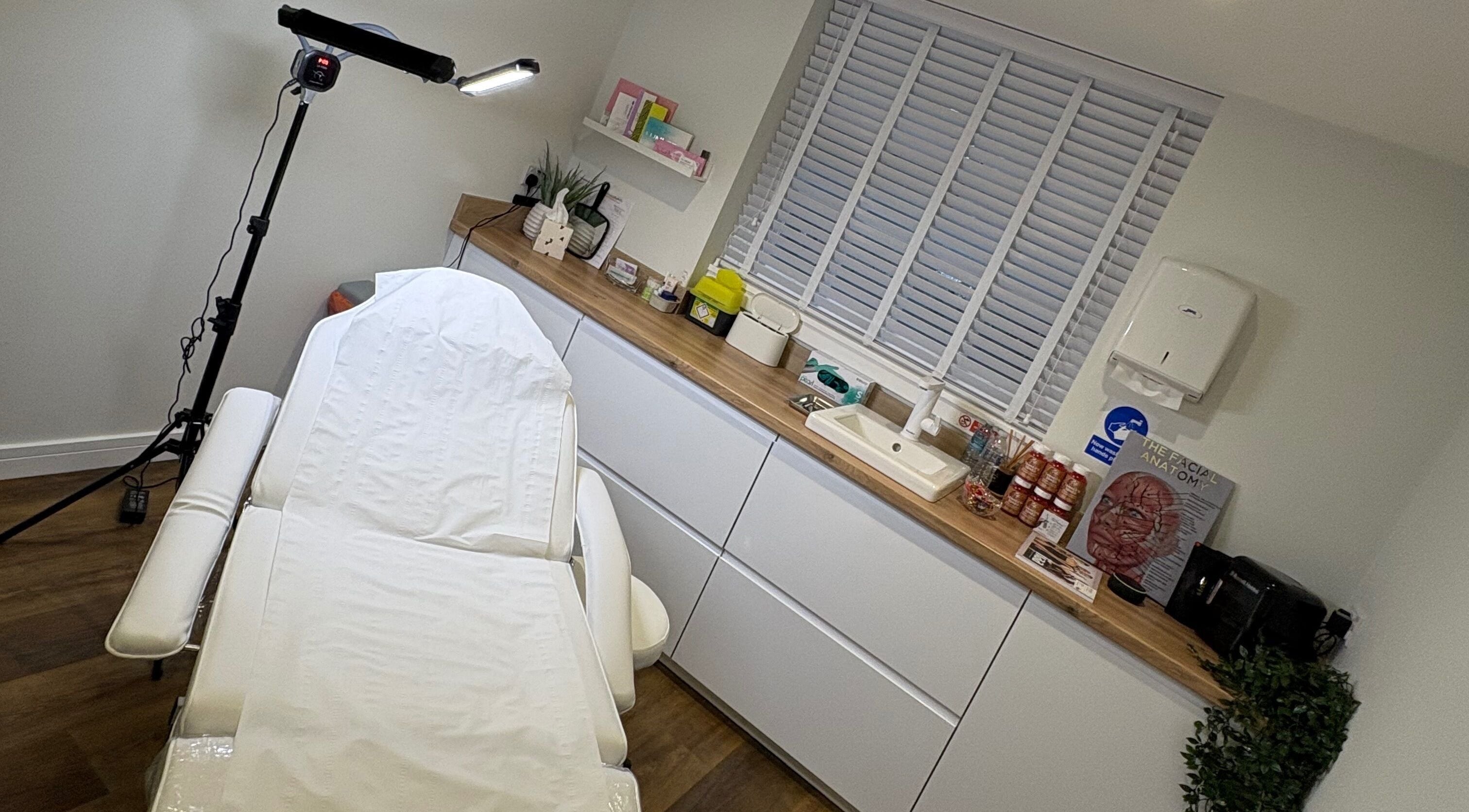 Treatment room at Enhance With Claire, Dunfermline, Scotland, GB with a luxurious massage bed and calming decor.
