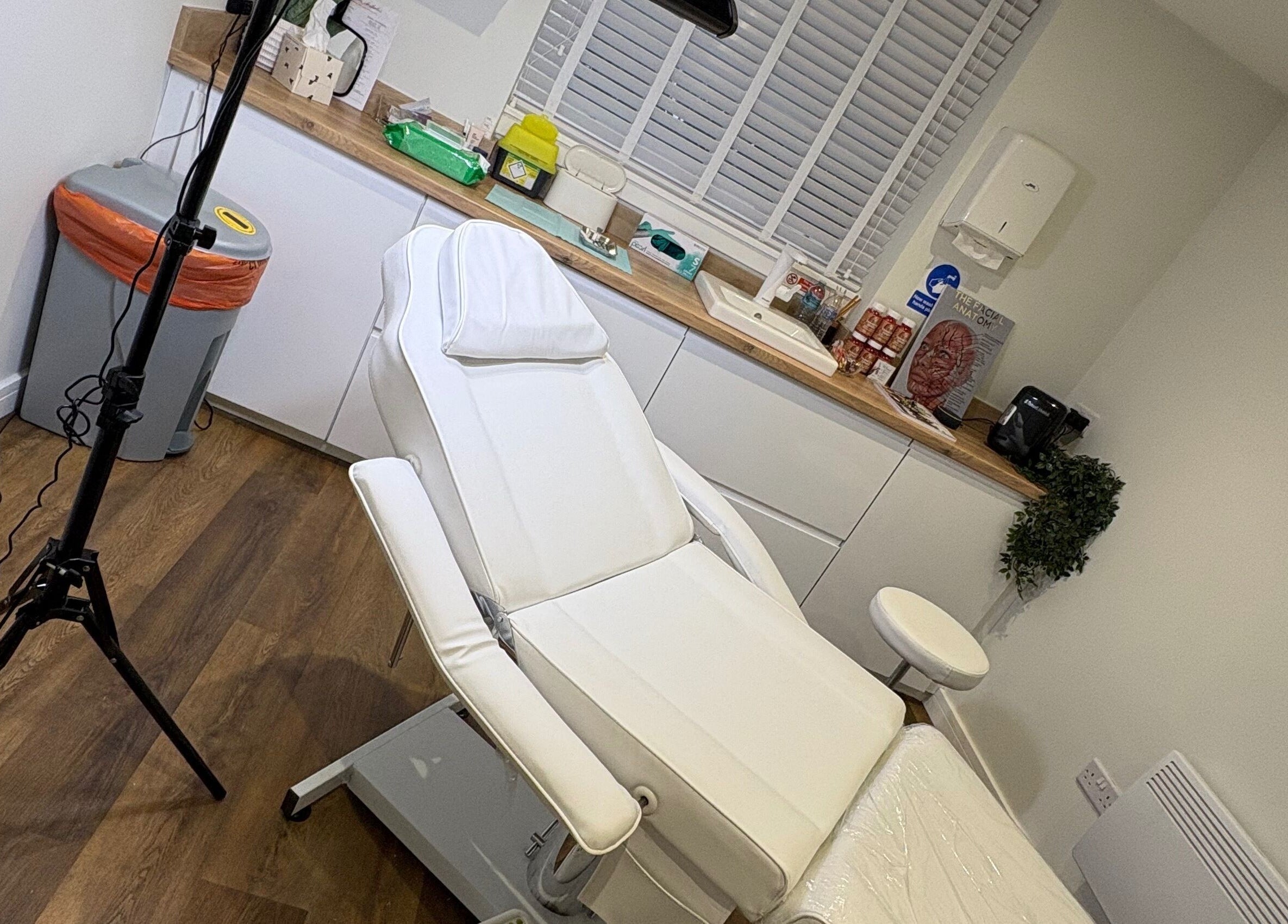 Relaxing treatment room at Enhance With Claire in Dunfermline, Scotland, GB, featuring a plush white chair.