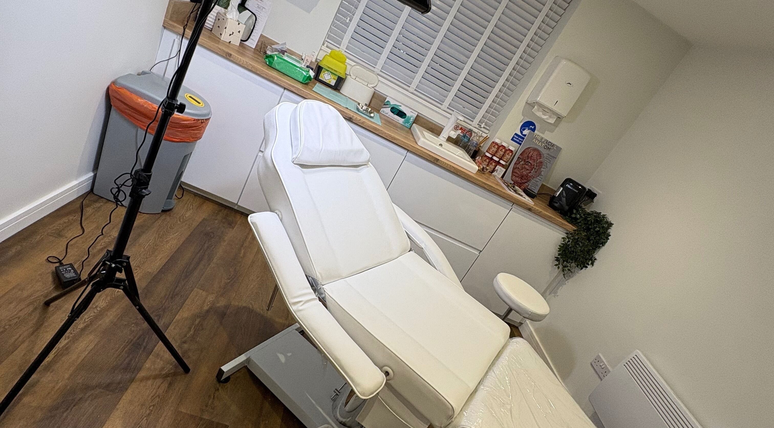 Relaxing treatment room at Enhance With Claire in Dunfermline, Scotland, GB, featuring a plush white chair.