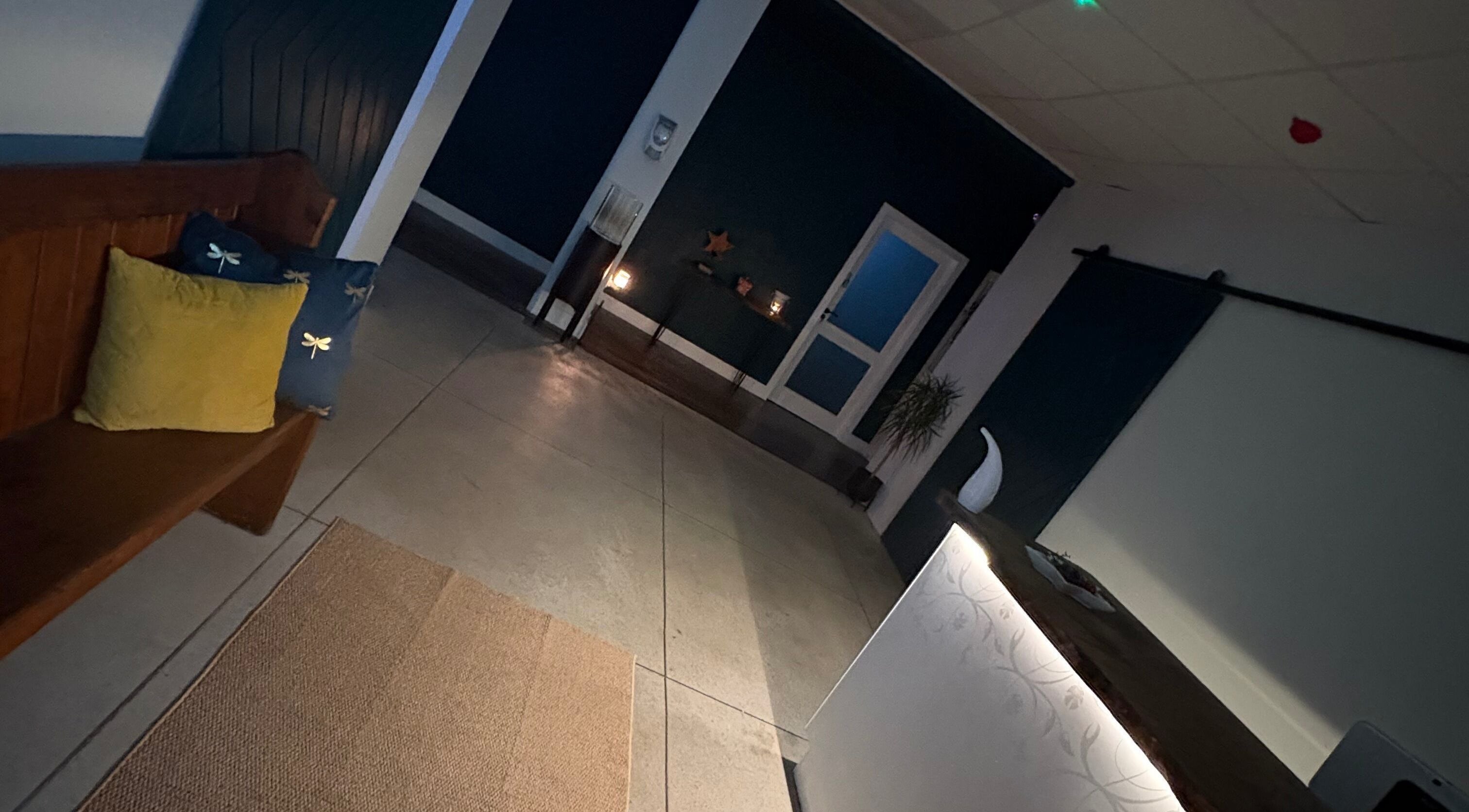 Inviting reception area at Enhance With Claire in Dunfermline, Scotland, GB with warm lighting and seating.