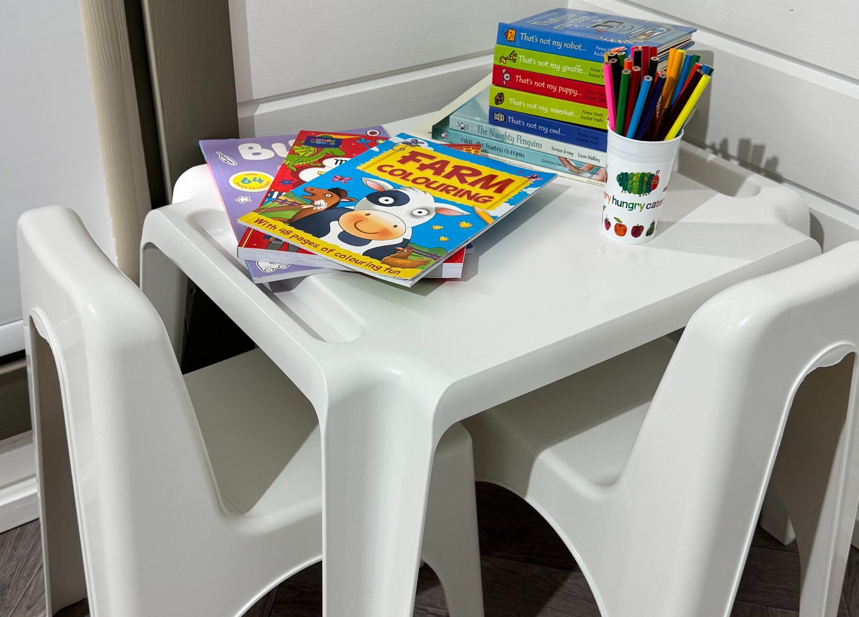 Children's coloring station at Silken Beauty by Sophie, Littleport, England, GB with books and pencils.