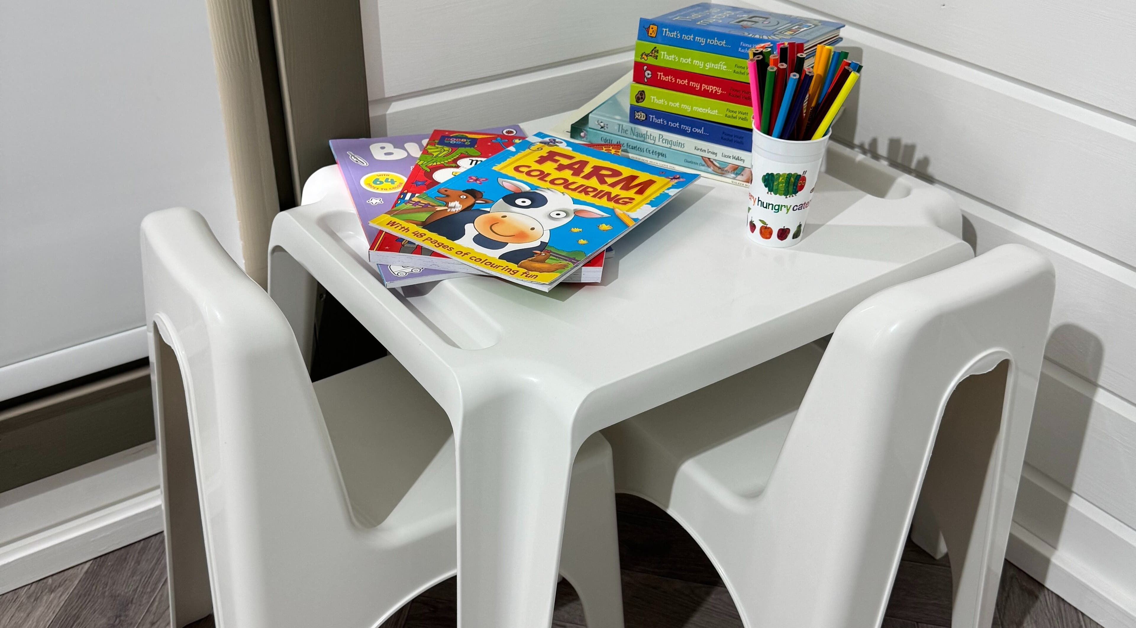 Children's coloring station at Silken Beauty by Sophie, Littleport, England, GB with books and pencils.