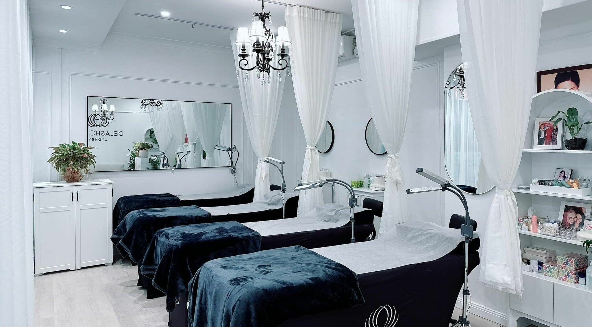 Chic beauty treatment room at DE LASH DOUBLE BAY, Double Bay, New South Wales, AU with cozy lash beds and elegant decor.