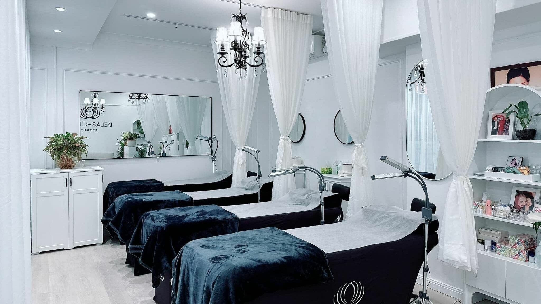 Chic beauty treatment room at DE LASH DOUBLE BAY, Double Bay, New South Wales, AU with cozy lash beds and elegant decor.