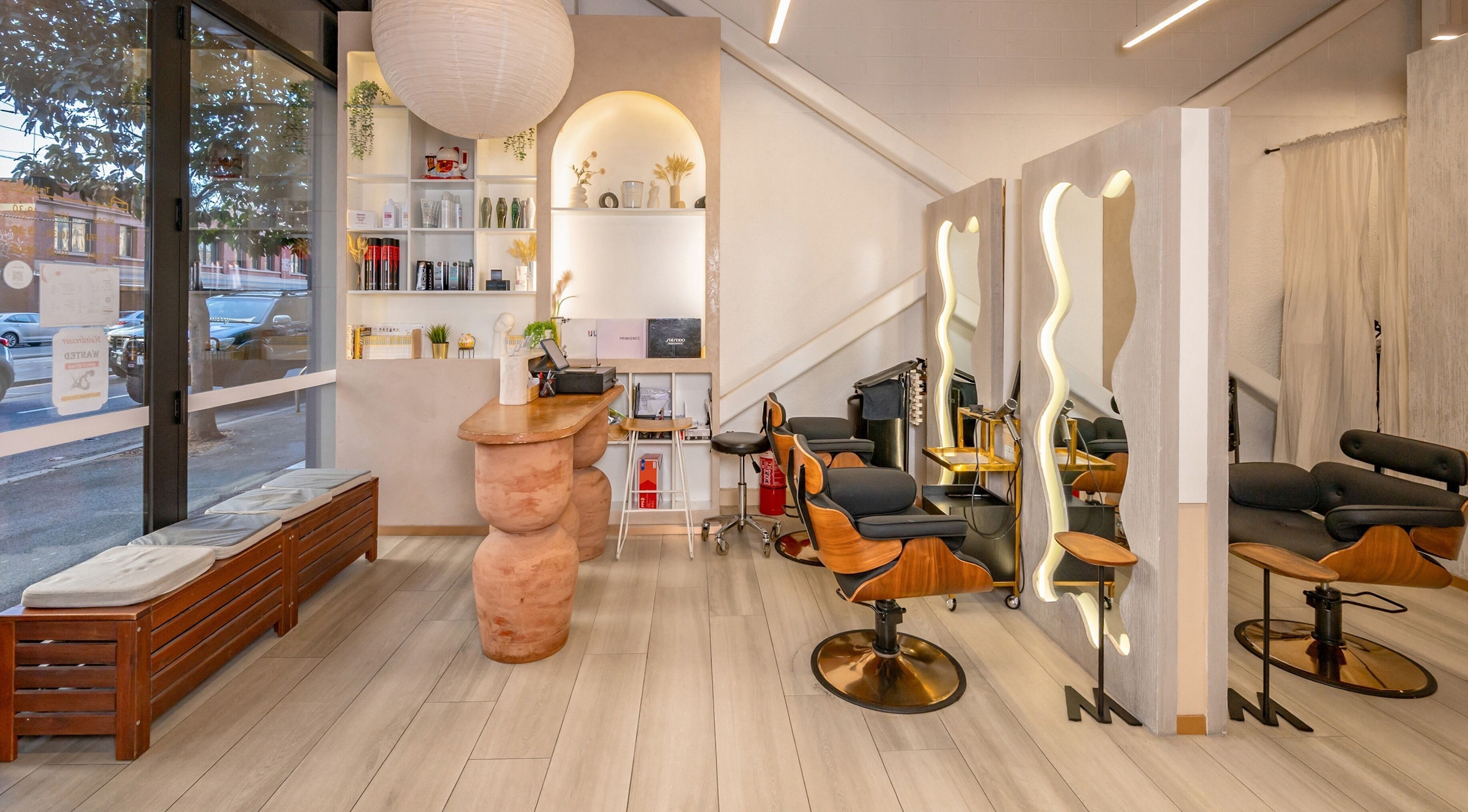 Modern salon interior at Katamo Hair Salon, Melbourne, Victoria, AU with stylish chairs and large mirrors.