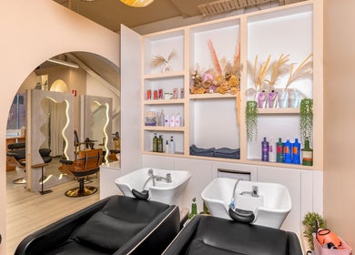 Stylish interior of Katamo Hair Salon in Melbourne, Victoria, AU with modern wash basins and product shelves.