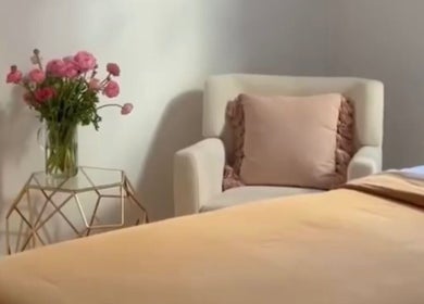Tranquil room at Rose Rituals, Melbourne, Victoria, AU, featuring cozy chair and elegant floral decor.