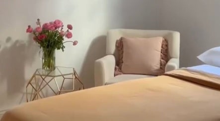 Tranquil room at Rose Rituals, Melbourne, Victoria, AU, featuring cozy chair and elegant floral decor.