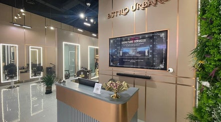 Stylish interior of Estilo Urbano Gents Salon in Umm Al Quwain, featuring modern seating and lush decor.