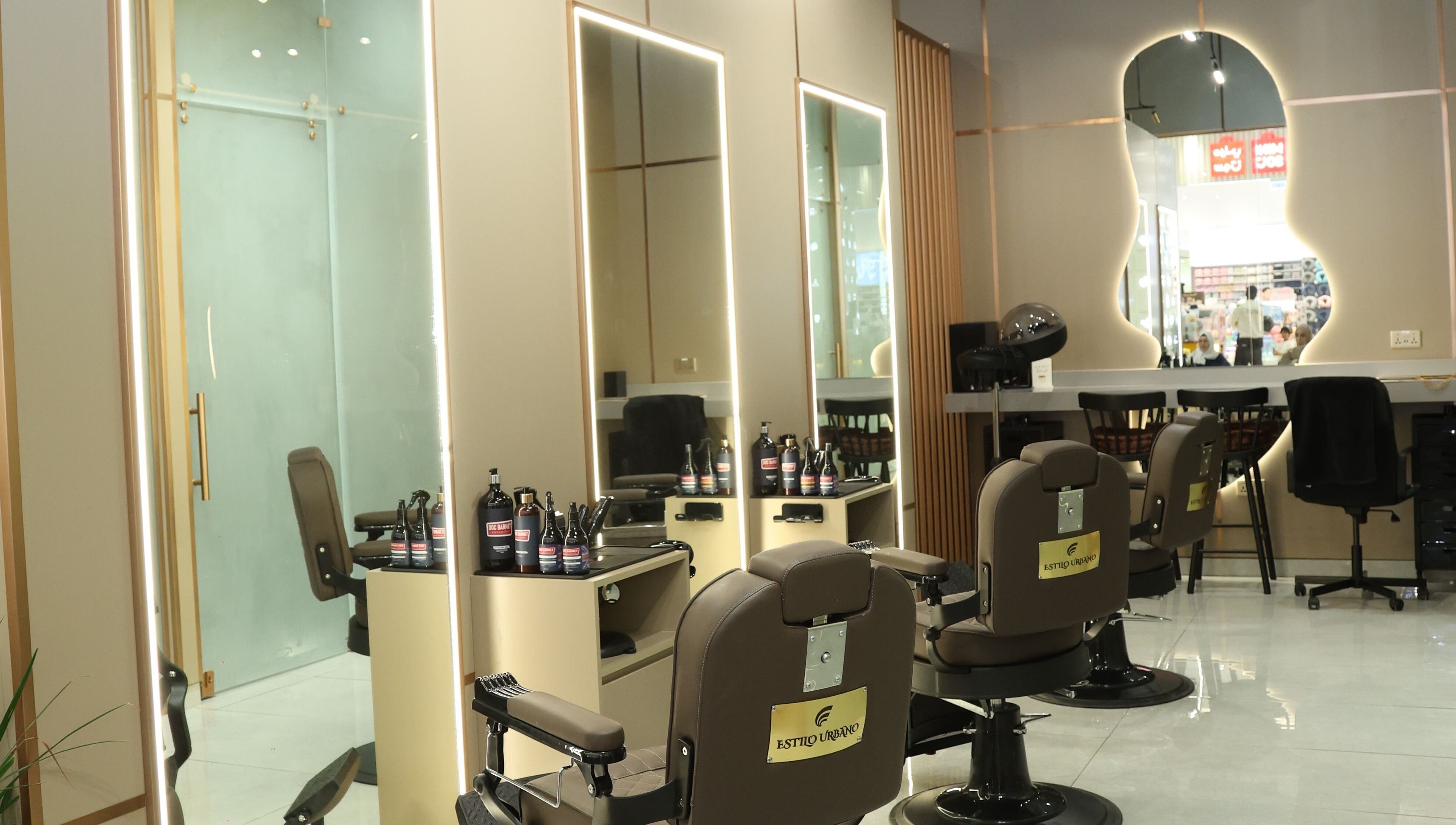 Interior of Estilo Urbano Gents Salon, Umm Al Quwain. Stylish barber chairs and mirrors in luxe setting.