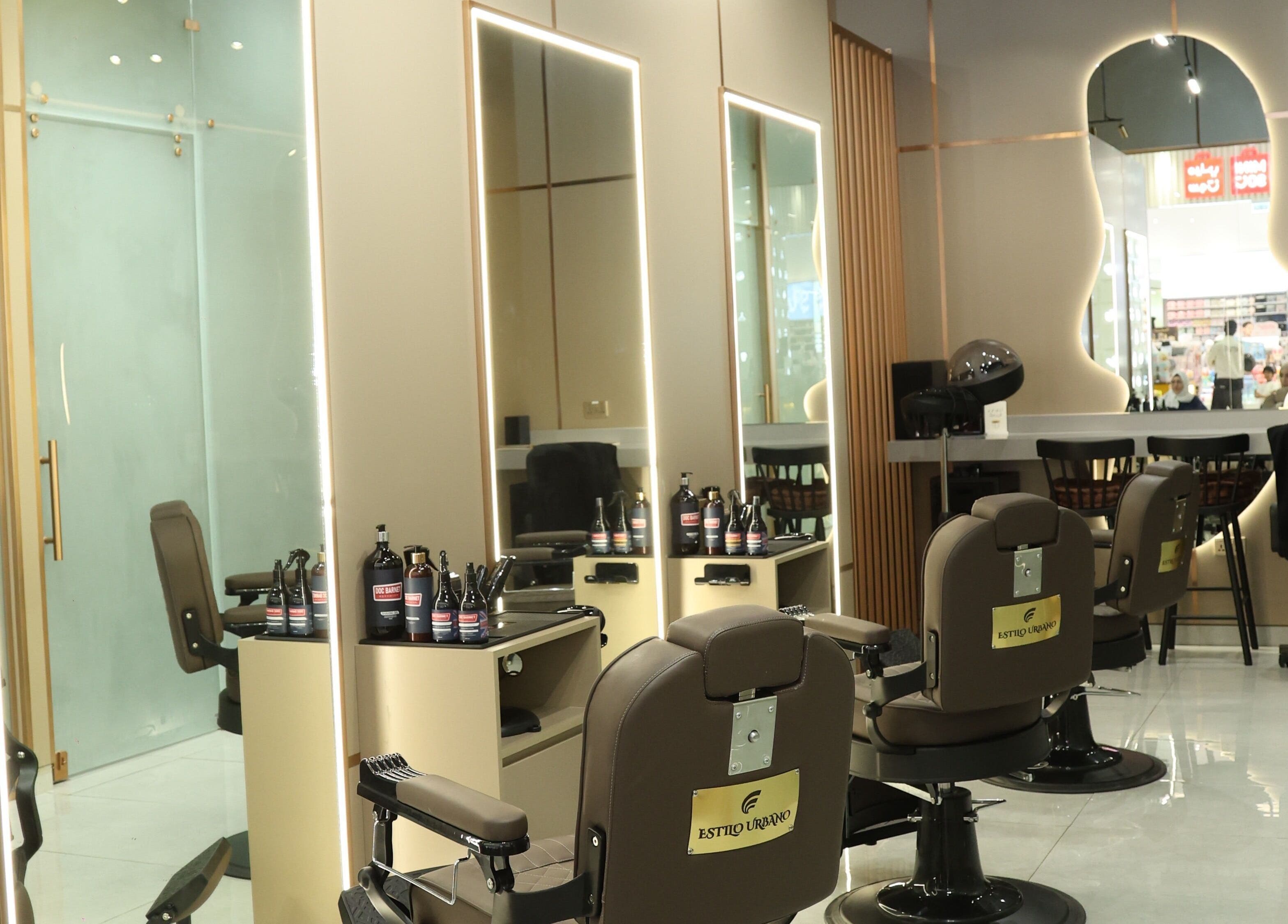 Interior of Estilo Urbano Gents Salon, Umm Al Quwain. Stylish barber chairs and mirrors in luxe setting.