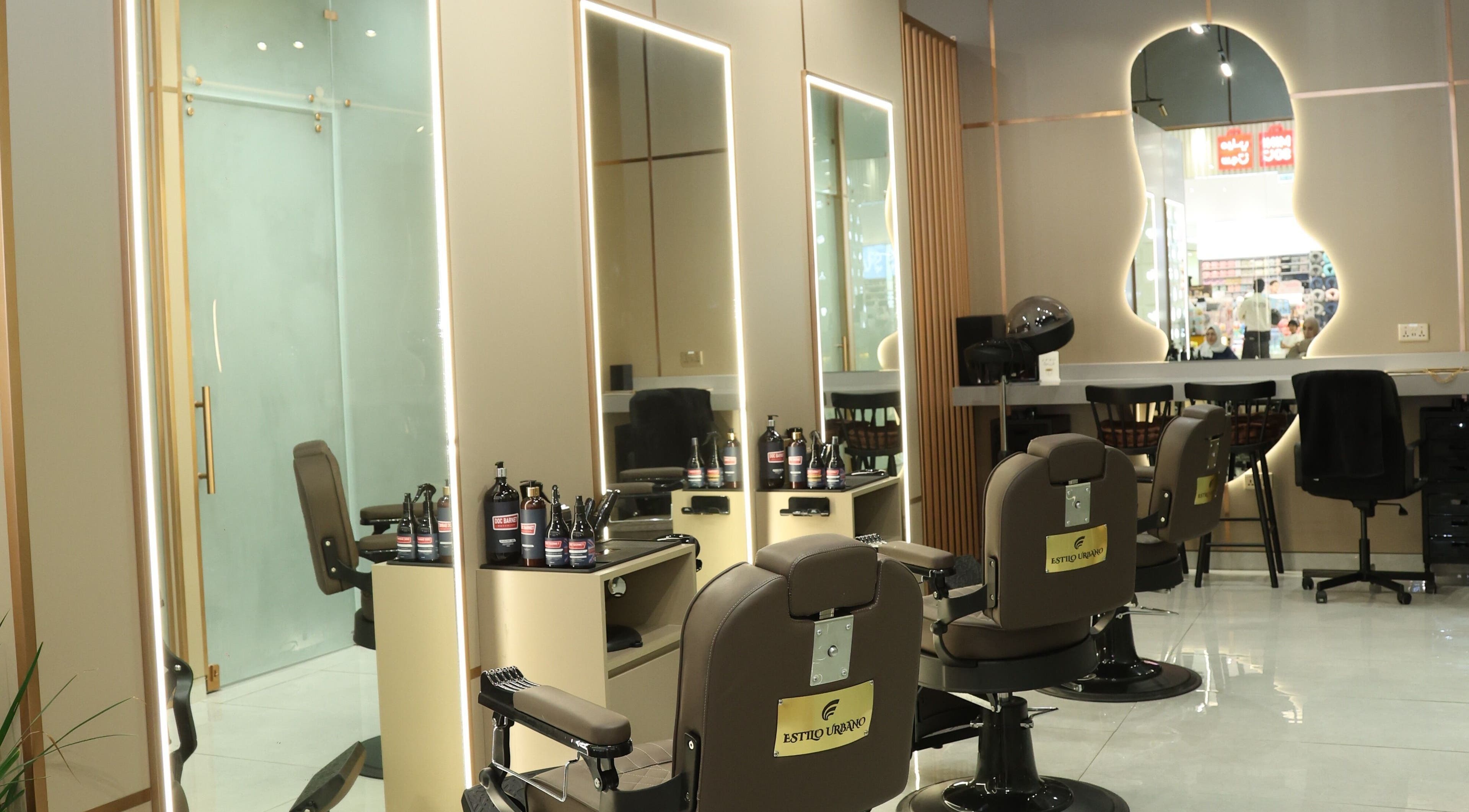 Interior of Estilo Urbano Gents Salon, Umm Al Quwain. Stylish barber chairs and mirrors in luxe setting.