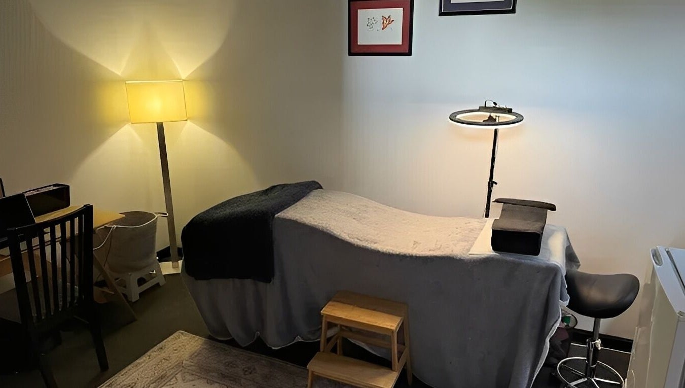 Relaxing treatment room at Designer Lashes in Trafalgar, Victoria, AU, featuring warm lighting and a comfortable bed.