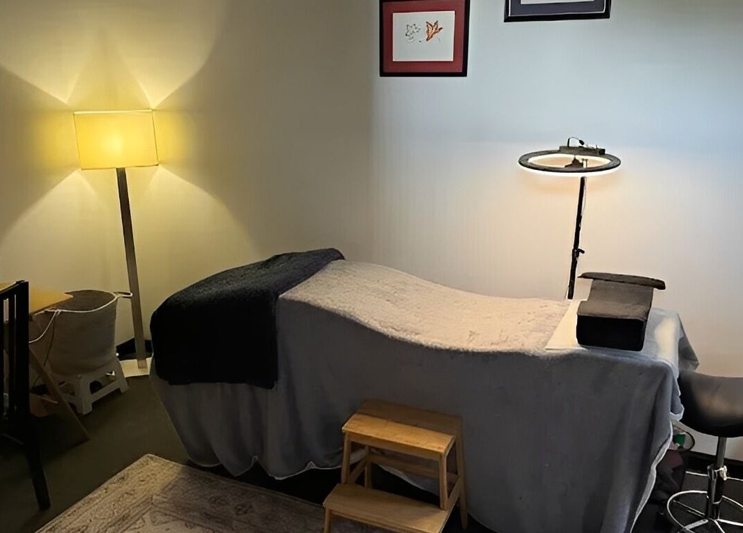 Relaxing treatment room at Designer Lashes in Trafalgar, Victoria, AU, featuring warm lighting and a comfortable bed.