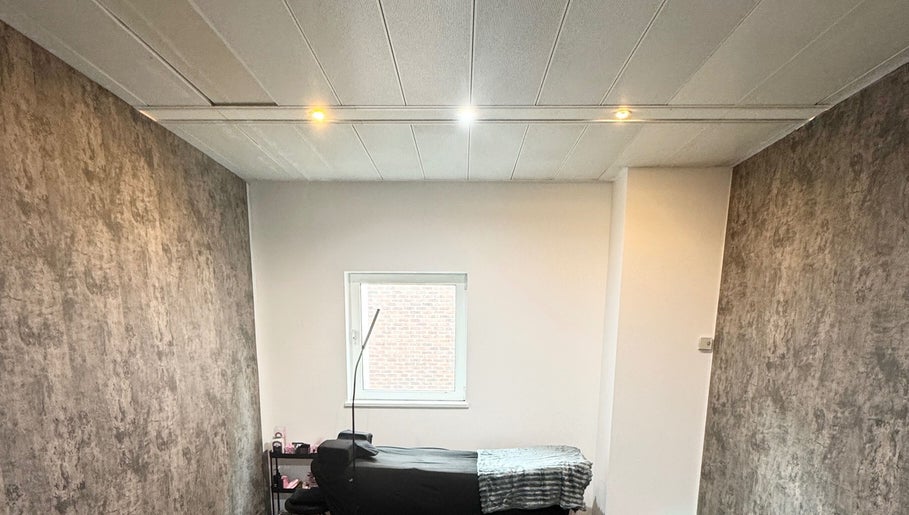 A cozy treatment room at The Blink Atelier LDN in London, England, GB featuring a massage bed and calming decor.