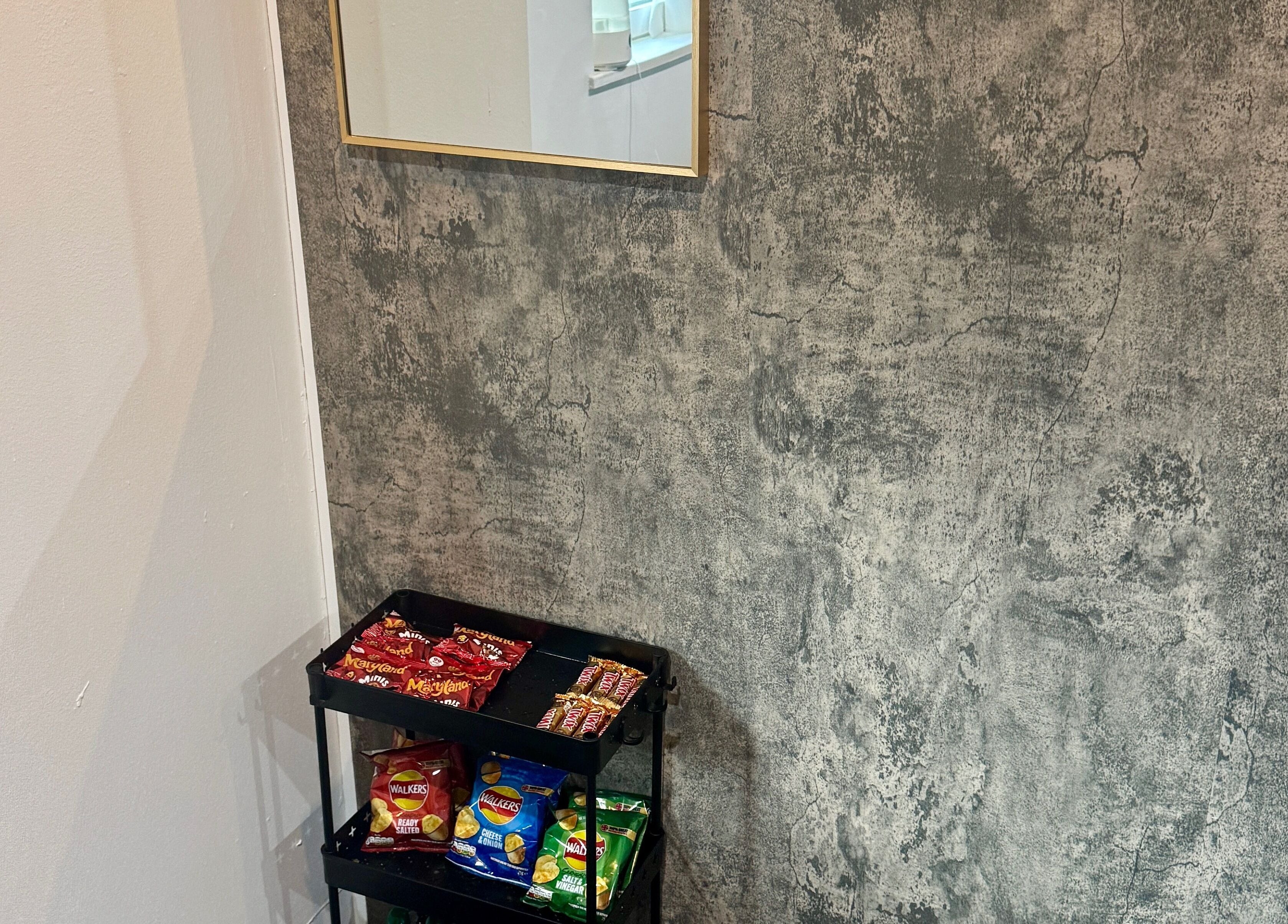 Snack station at The Blink Atelier LDN, London, England, GB with stylish concrete wall backdrop.