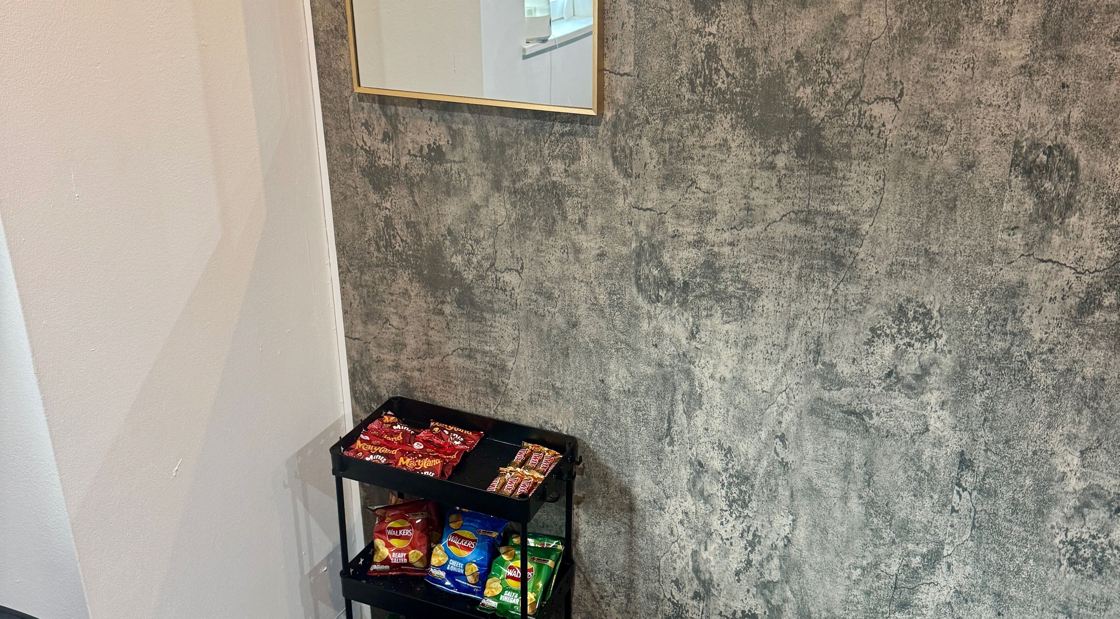 Snack station at The Blink Atelier LDN, London, England, GB with stylish concrete wall backdrop.