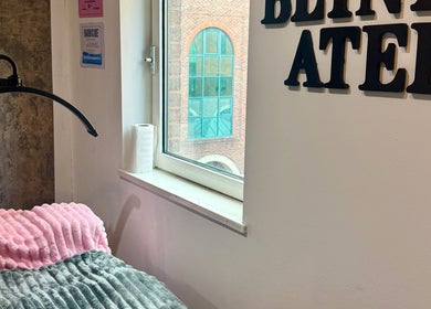Cozy beauty treatment area inside The Blink Atelier LDN, London, England, GB with soft lighting.