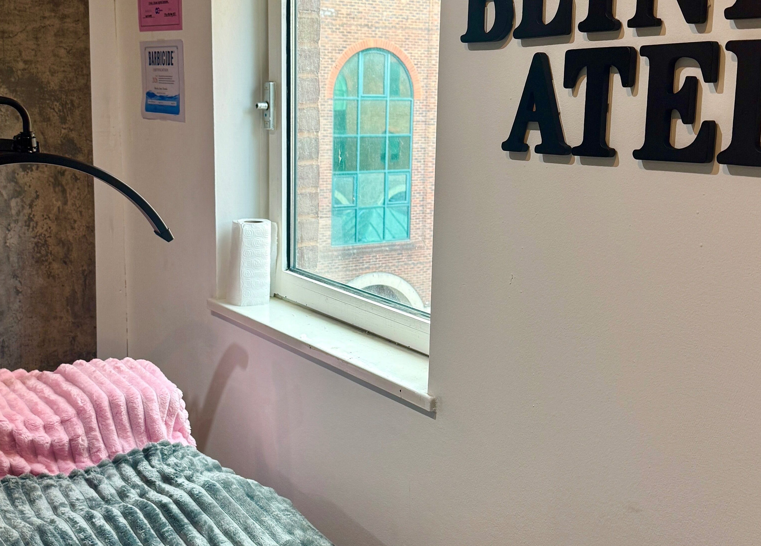 Cozy beauty treatment area inside The Blink Atelier LDN, London, England, GB with soft lighting.