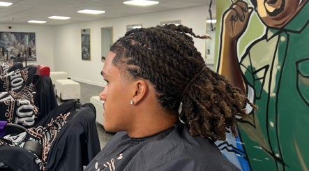 Man with trendy braids at MG TRIMZ, Leeds, England, GB.